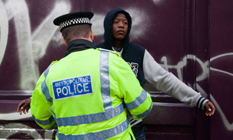 A young black man is stopped and searched by a Metropolitan police officer in London.
Photograph: OnTheRoad/Alamy