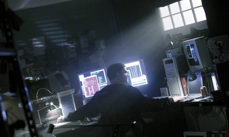 Hacker surrounded by computers