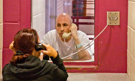 prisoner talking through glass