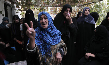 A Palestinian woman makes the victory sign during the funeral of a child killed in an Israeli attack in Gaza last week.  Photograph: Said Khatib/AFP/Getty Images