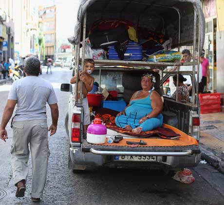 A family living in the back of a pickup truck in Athens. Photograph: Oli Scarff/Getty Images
