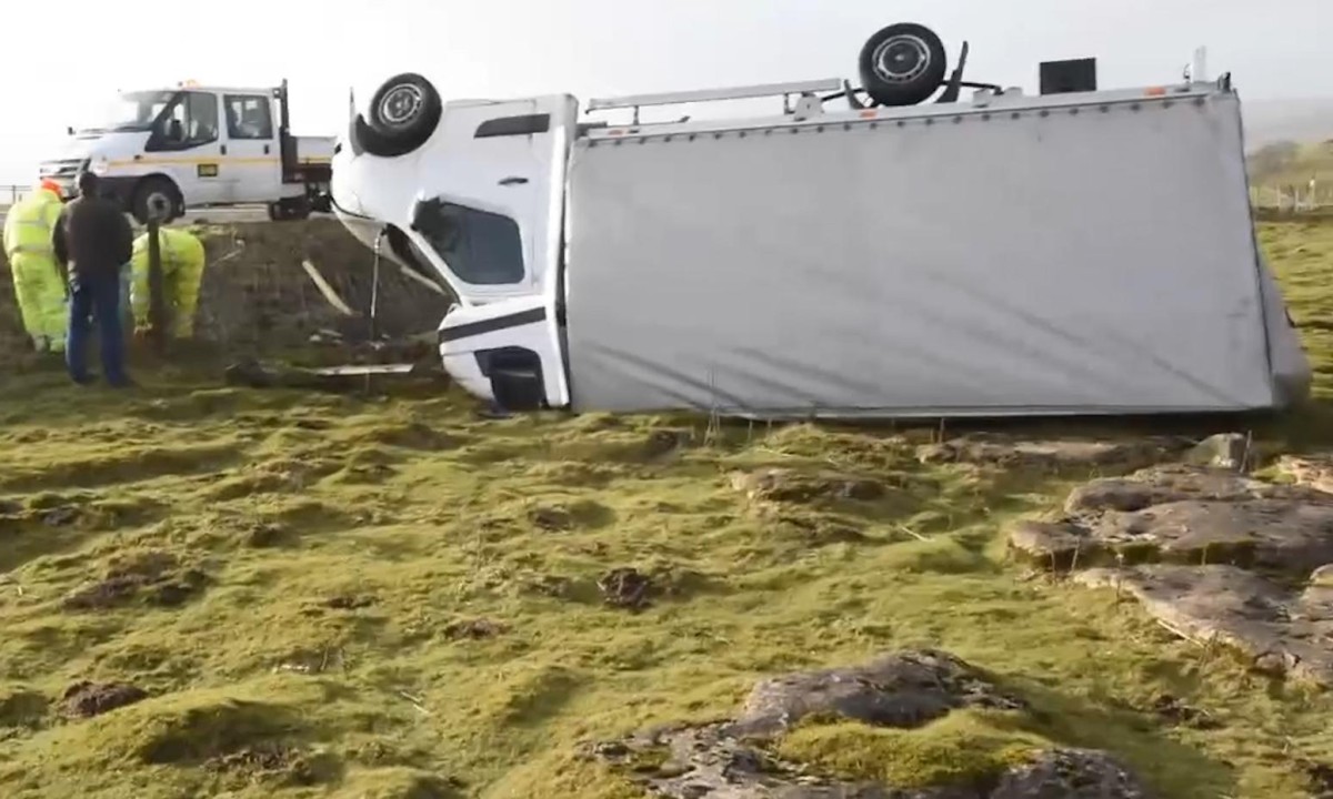 Lorry blown off the road as Storm Henry hits the UK – video