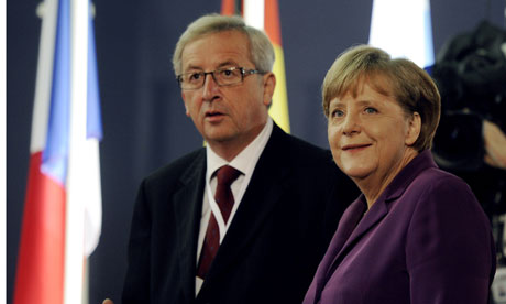 Jean-Claude Juncker, Luxembourg's PM, with the German chancellor, Angela Merkel, in Cannes. Juncker issued a stark warning that the next portion of the bailout package may not be released. Photograph: Lionel Bonaventure/AFP/Getty Images