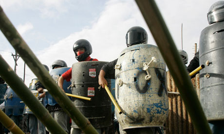 Pinheirinho squatters wearing improvised armour stand ready to resist the police. Photograph: Reuters