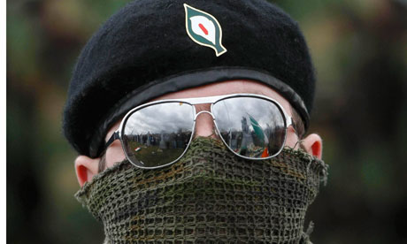 A masked member of the Real IRA at a republican Easter commemoration ceremony in Derry. The Real IRA is merging with other dissident groups in an escalation of the threat of violence against security forces. Photograph: Niall Carson/PA