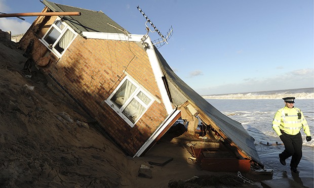 East coast surge homes  fall into  sea  waves rip at pier 