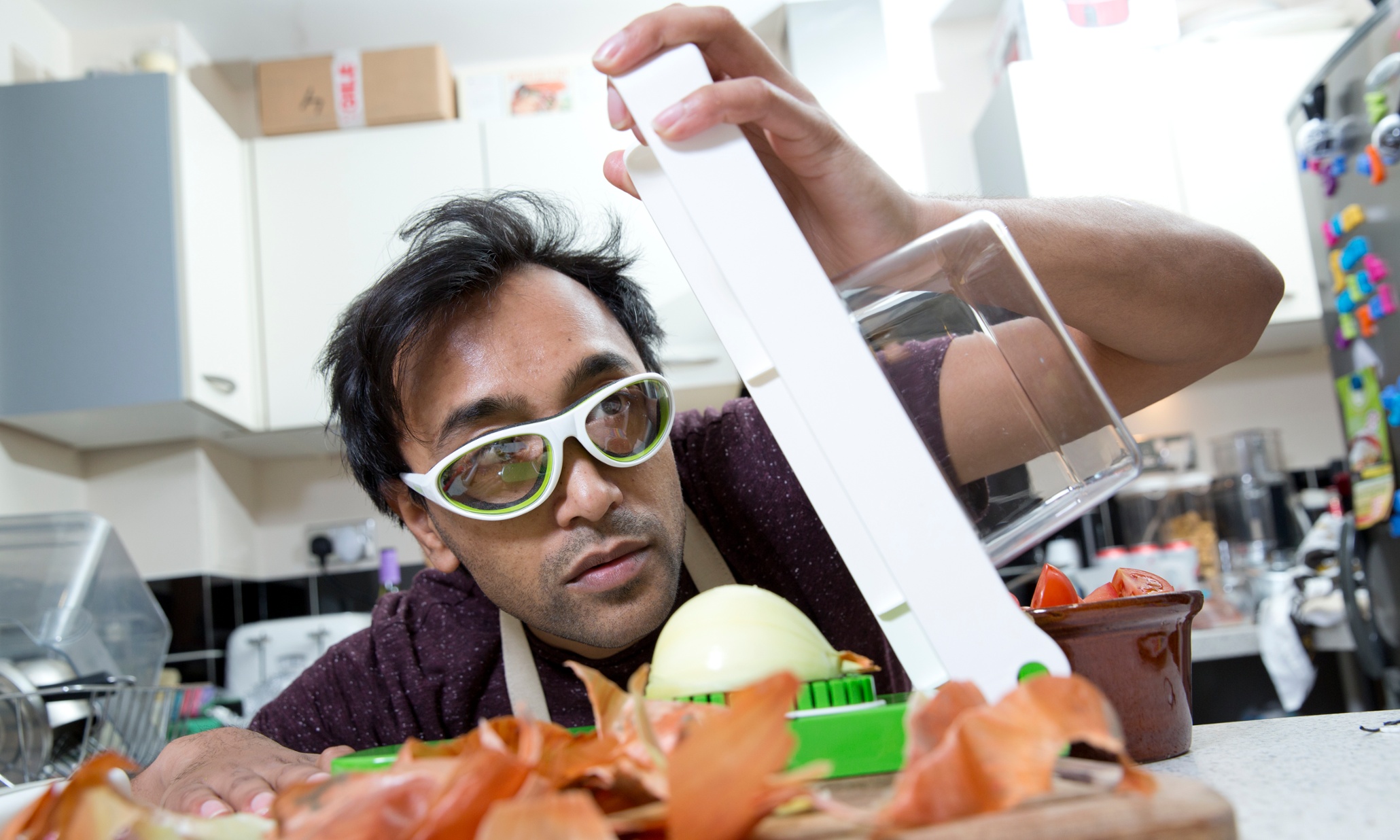 Rhik chops an onion with the Alligator Onion Cutter and John Lewis Onion Goggles